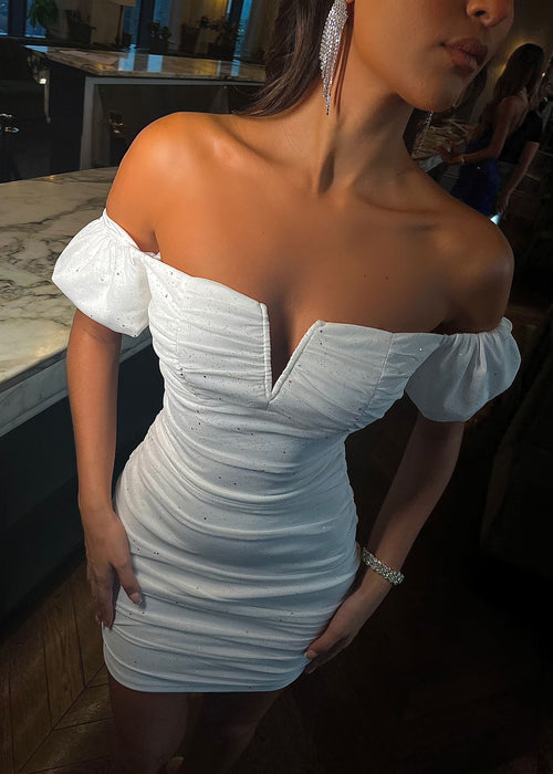 Women's white sparkly mini dress with off the shoulder sleeves and ruched mesh fabric overlay.