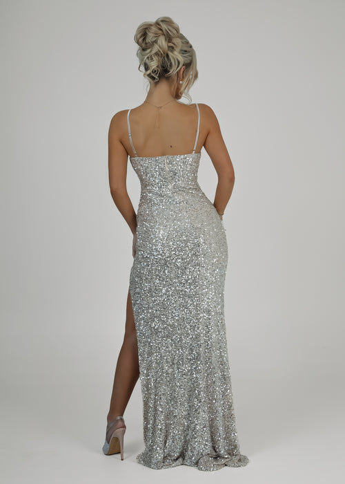 Women's champagne prom gown fully embellished with sparkling sequin, thigh slit, corset bodice and spaghetti straps with a figure hugging fit. 