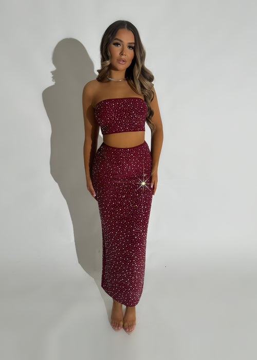 Women's embellished burgundy two-piece set. Bandeau crop top fully embellished in hot fix and matching burgundy maxi skirt with thigh high slit.