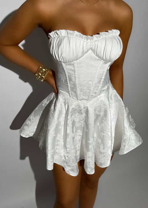 Women's strapless white mini dress. White satin jacquard fabric, structured corset bodice with boning and floaty skirt.