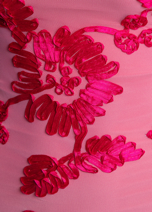 Women's pink mini dress with long sleeves and flared cuffs. 3D floral embroidery embellished throughout fabric. Model is 5ft2' and wears a size XS 6.