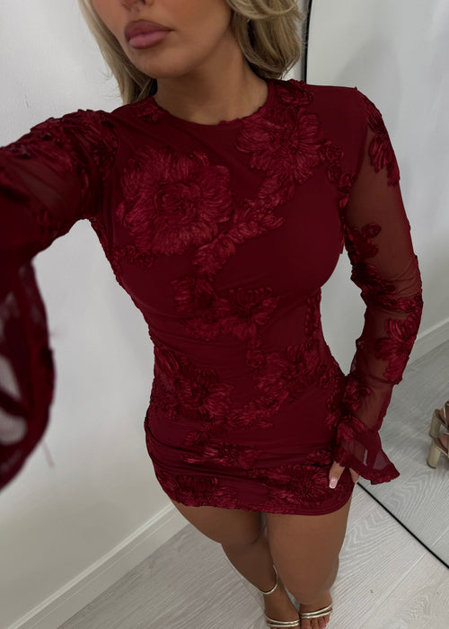Women's long sleeved mini dress with embroidered mesh fabric and flared long sleeves. Bodycon fit. Burgundy. Model wears a size S 8.