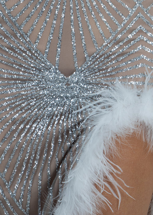 Women's silver glitter sparkly prom gown with silver glitter pattern throughout fabric and thigh high slit with white feather trim. Model is 5ft6' and wears a size S 8.