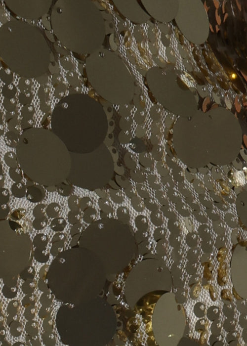 Women's gold mini skirt embellished with large disc sequins and small gold sparkly sequins. Model is 5ft7' and wears a size S 8.