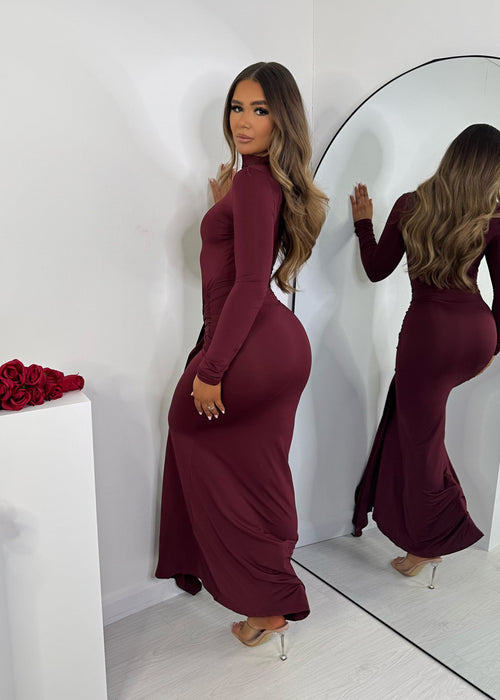 Burgundy maxi dress with long sleeves and a versatile multi-way front tie detail for customizable styling. Elegant and flowing design, modelled by a 5'6" person wearing size S (6-8).