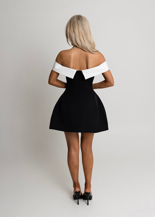 Women's structured monochrome mini dress with a bardot neckline, fitted waist and flared skirt. Model is 5ft6' and wears a size S 8.