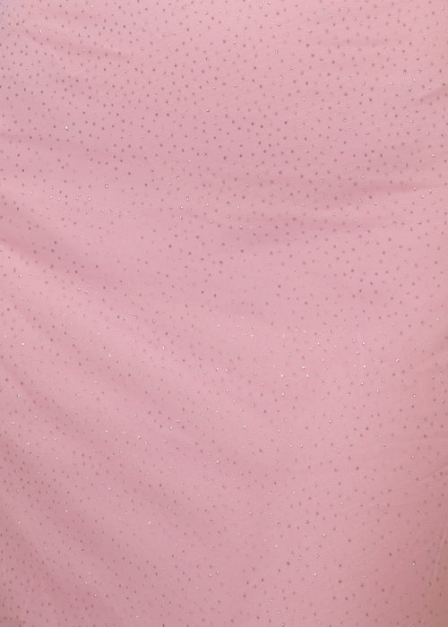 Close up fabric swatch of baby pink fabric with small specs of pink glitter embellished all over.