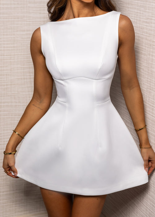 Women's white mini dress with A-line silhouette  and structured fit.
