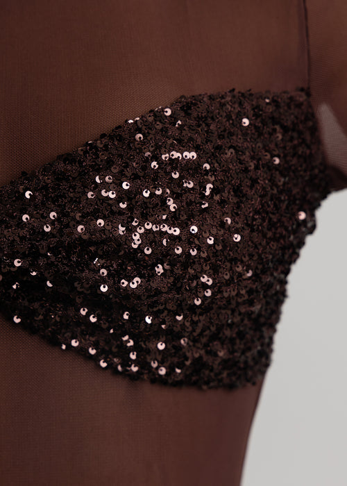 Close up detail of brown sequin embellishments on fabric.