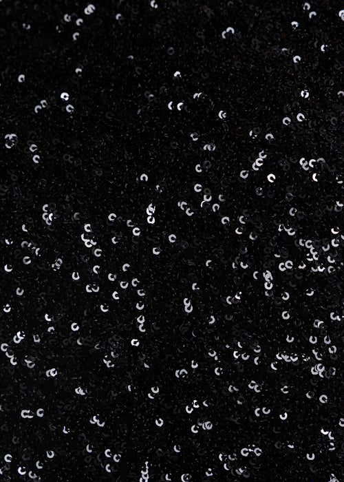 Close up image of black fabric fully embellished with black shiny sequins. 