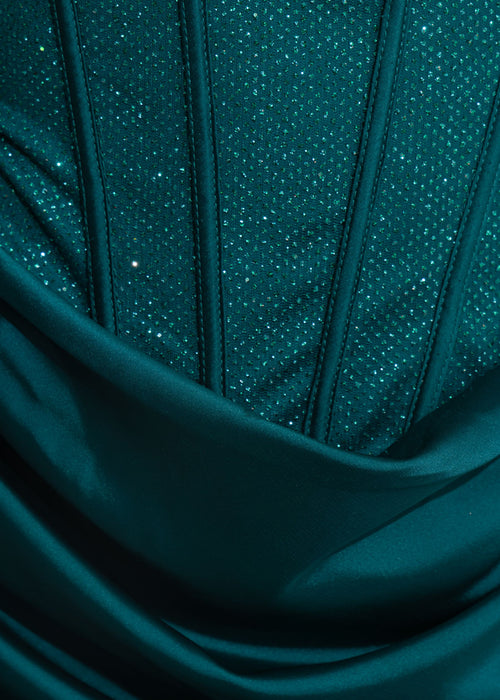 Close up swatch of dress details showing teal glitter embellished fabric.
